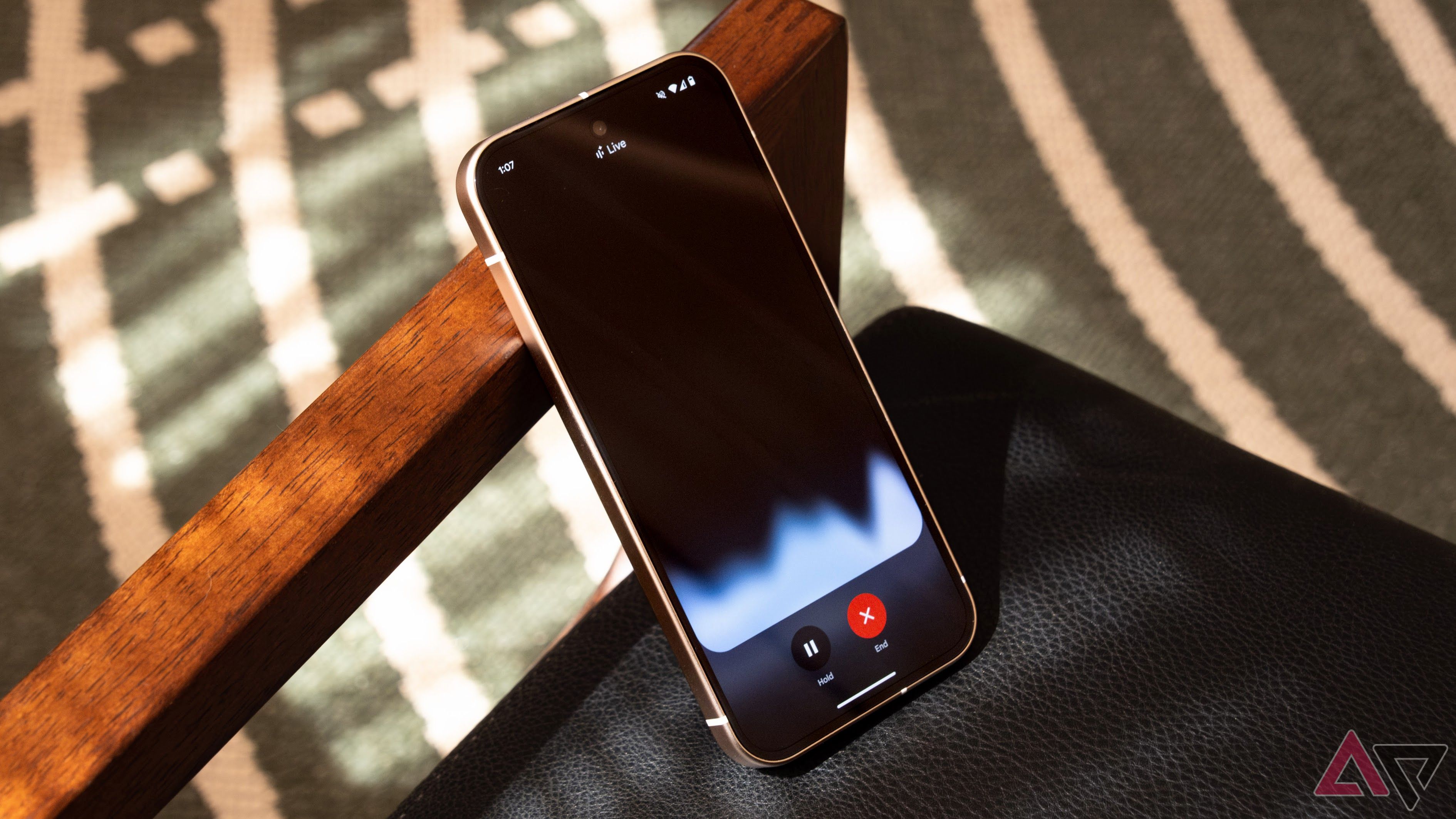 Gemini Live Running en un teléfono Pixel 9 en un sillón de cuero.